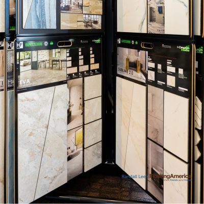 Showroom tile display featuring Happy Floors' EVA and SUBLIME 2.0 collections with large samples, swatches, and lifestyle photos.